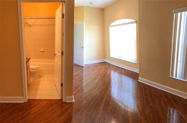 6517 Channelside Dr, New Port Richey, FL 34652 - unfurnished bedroom featuring dark wood-style flooring and ensuite bath