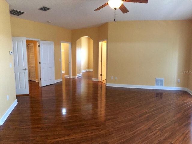 6517 Channelside Dr, New Port Richey, FL 34652 - unfurnished room featuring ceiling fan, arched walkways, and dark wood-type flooring