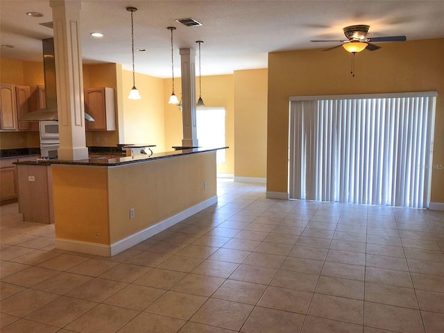 6517 Channelside Dr, New Port Richey, FL 34652 - kitchen featuring ceiling fan, light tile patterned flooring, pendant lighting, wall chimney range hood, and recessed lighting