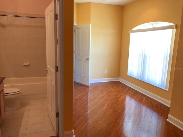6517 Channelside Dr, New Port Richey, FL 34652 - bathroom featuring wood finished floors and tub / shower combination