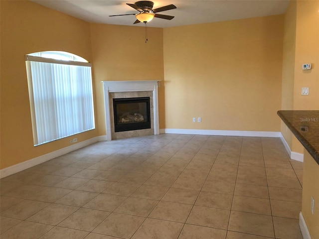 6517 Channelside Dr, New Port Richey, FL 34652 - unfurnished living room featuring a ceiling fan, light tile patterned floors, and a fireplace