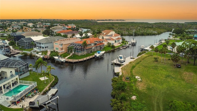 6517 Channelside Dr, New Port Richey, FL 34652 - aerial view at dusk of a water view and a residential view