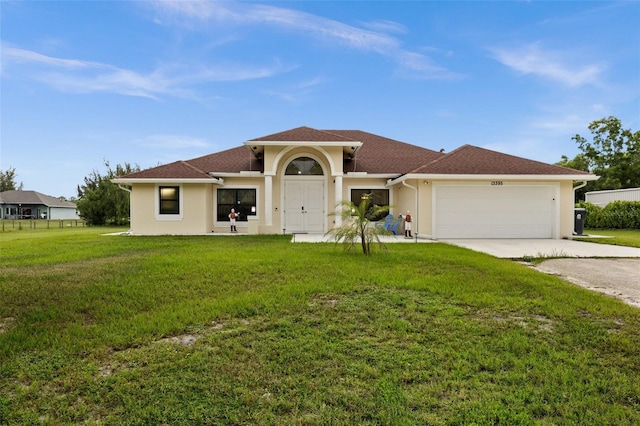13395 59th Ct N, West Palm Beach, FL 33411 - mediterranean / spanish home featuring an attached garage, driveway, stucco siding, and a front yard