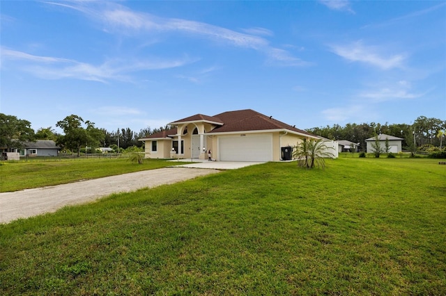 13395 59th Ct N, West Palm Beach, FL 33411 - view of front of home featuring driveway, an attached garage, a front yard, and stucco siding