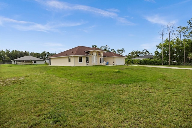 13395 59th Ct N, West Palm Beach, FL 33411 - rear view of house with a yard and stucco siding
