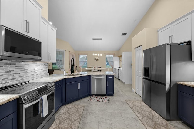 13395 59th Ct N, West Palm Beach, FL 33411 - kitchen featuring appliances with stainless steel finishes, vaulted ceiling, a peninsula, tasteful backsplash, and blue cabinets