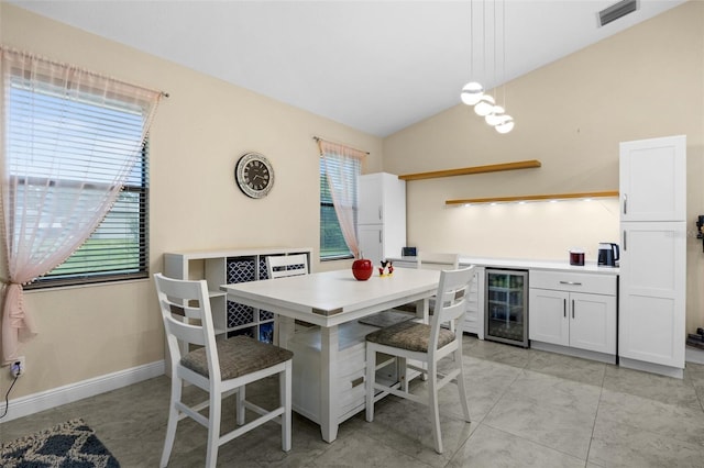 13395 59th Ct N, West Palm Beach, FL 33411 - dining room with wine cooler, a bar, and vaulted ceiling