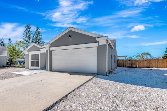 5682 25th Street Cir E, Bradenton, FL 34203 - view of front of home with stucco siding, an attached garage, and concrete driveway