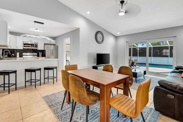 5682 25th Street Cir E, Bradenton, FL 34203 - dining space featuring vaulted ceiling, light tile patterned floors, a textured ceiling, and recessed lighting