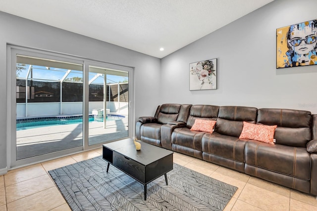 5682 25th Street Cir E, Bradenton, FL 34203 - living room featuring a sunroom, lofted ceiling, light tile patterned floors, and a textured ceiling