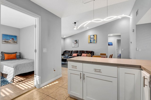 5682 25th Street Cir E, Bradenton, FL 34203 - kitchen featuring open floor plan, white cabinets, light tile patterned flooring, decorative light fixtures, and light countertops