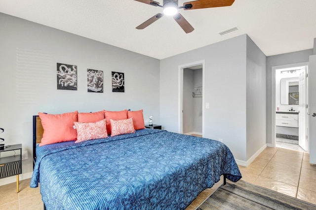 5682 25th Street Cir E, Bradenton, FL 34203 - bedroom with light tile patterned floors, a ceiling fan, and a walk in closet