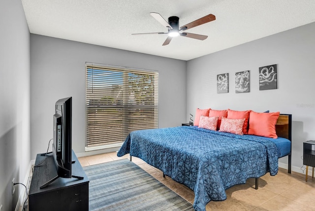 5682 25th Street Cir E, Bradenton, FL 34203 - bedroom with light tile patterned flooring, ceiling fan, and a textured ceiling