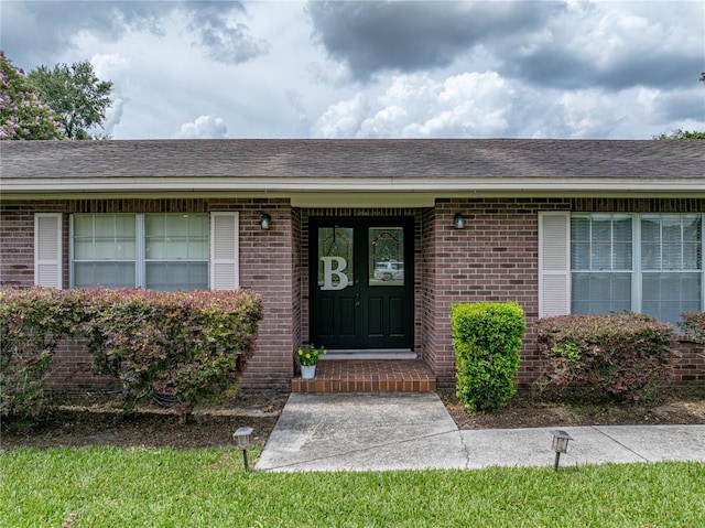 609 W Pipkin Rd, Lakeland, FL 33813 - entrance to property featuring brick siding and roof with shingles