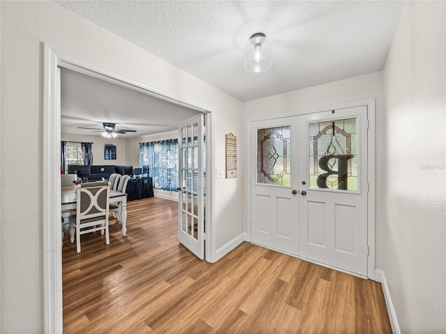 609 W Pipkin Rd, Lakeland, FL 33813 - entrance foyer with french doors, light wood-style floors, a textured ceiling, and ceiling fan