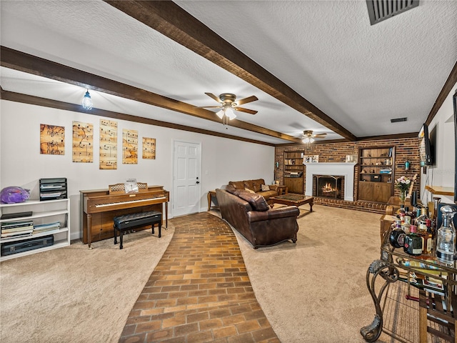 609 W Pipkin Rd, Lakeland, FL 33813 - living area featuring brick patterned floors, ceiling fan, beamed ceiling, a textured ceiling, and a brick fireplace