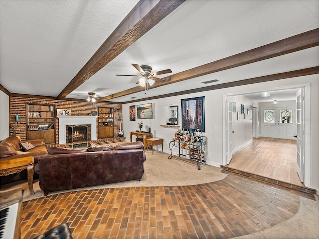 609 W Pipkin Rd, Lakeland, FL 33813 - living area with ceiling fan, beam ceiling, and a brick fireplace