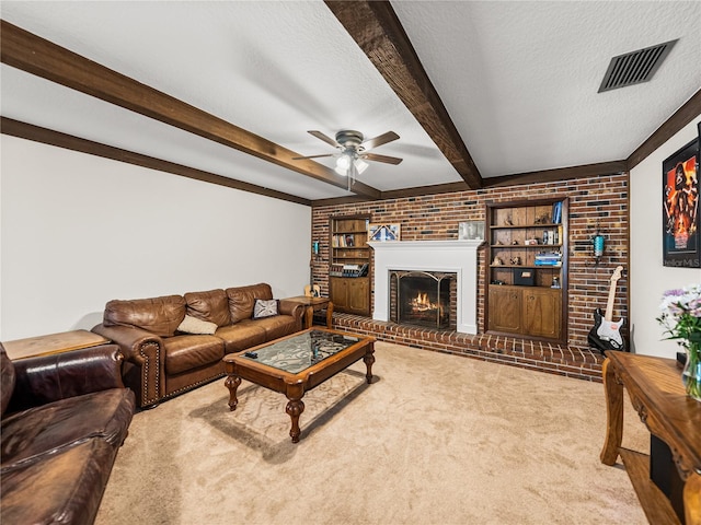 609 W Pipkin Rd, Lakeland, FL 33813 - living area with a ceiling fan, carpet floors, a fireplace, beamed ceiling, and a textured ceiling