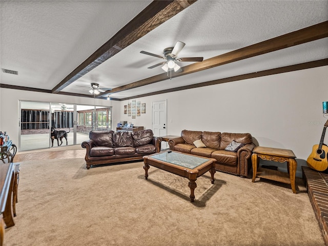 609 W Pipkin Rd, Lakeland, FL 33813 - living room featuring ceiling fan, beam ceiling, a textured ceiling, and carpet floors