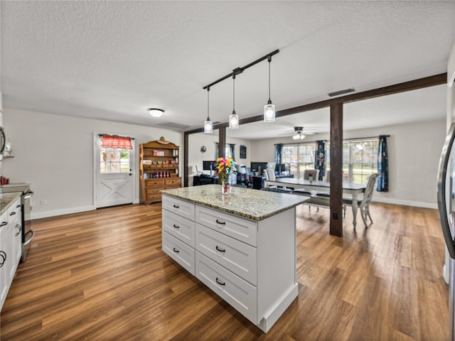 609 W Pipkin Rd, Lakeland, FL 33813 - kitchen with dark wood-type flooring, a textured ceiling, white cabinets, decorative light fixtures, and ceiling fan