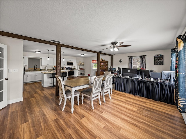 609 W Pipkin Rd, Lakeland, FL 33813 - dining space with ceiling fan, wood finished floors, and a textured ceiling