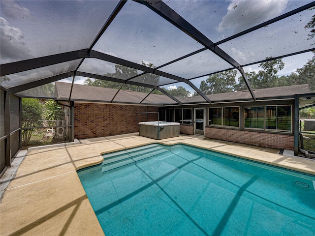 609 W Pipkin Rd, Lakeland, FL 33813 - swimming pool with a hot tub, a patio, and glass enclosure