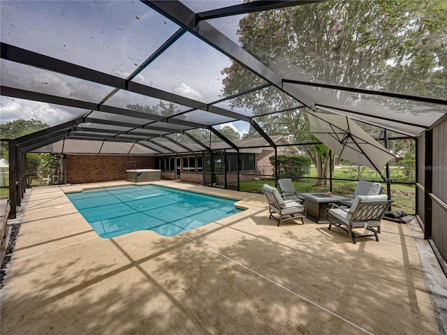 609 W Pipkin Rd, Lakeland, FL 33813 - swimming pool featuring a patio, a hot tub, glass enclosure, and an outdoor fire pit