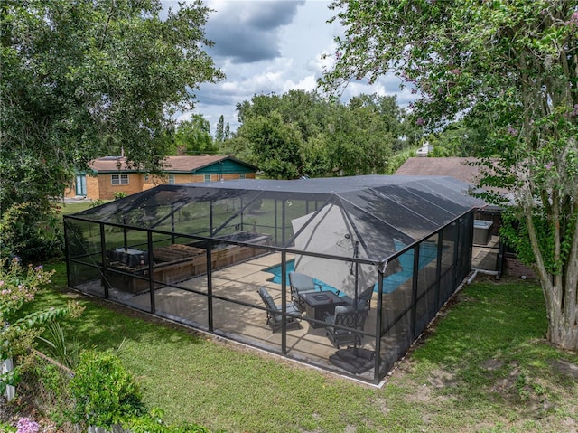 609 W Pipkin Rd, Lakeland, FL 33813 - swimming pool with a patio area, glass enclosure, and a yard