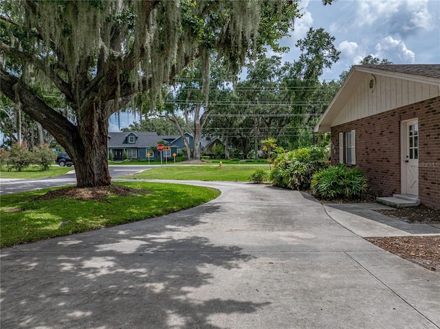 609 W Pipkin Rd, Lakeland, FL 33813 - view of property exterior featuring brick siding and a yard