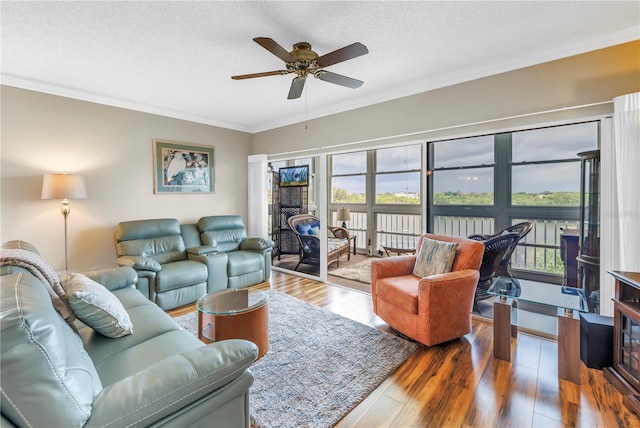 6399 Shoreline Dr Unit 4201, Saint Petersburg, FL 33708 - living area featuring crown molding, ceiling fan, wood finished floors, and a textured ceiling