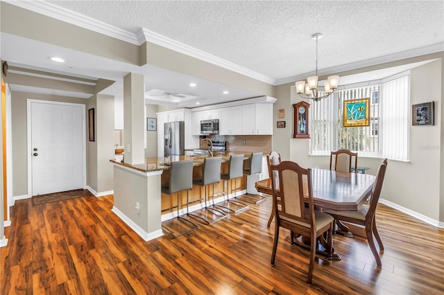 6399 Shoreline Dr Unit 4201, Saint Petersburg, FL 33708 - dining room featuring ornamental molding, dark wood-style floors, a textured ceiling, a chandelier, and recessed lighting