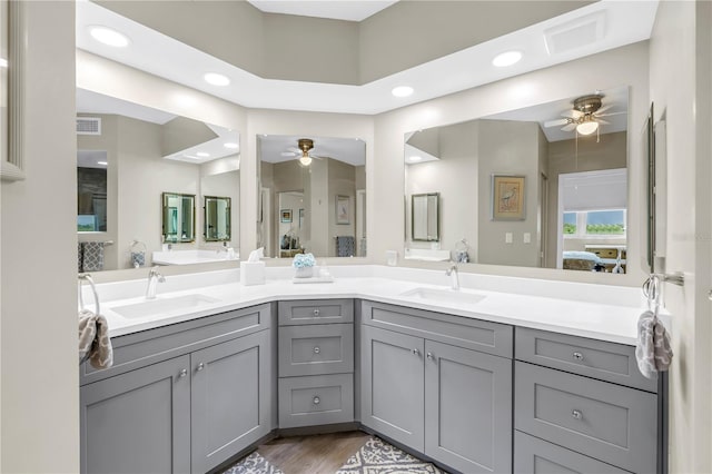 6399 Shoreline Dr Unit 4201, Saint Petersburg, FL 33708 - ensuite bathroom with a ceiling fan, double vanity, recessed lighting, and wood finished floors