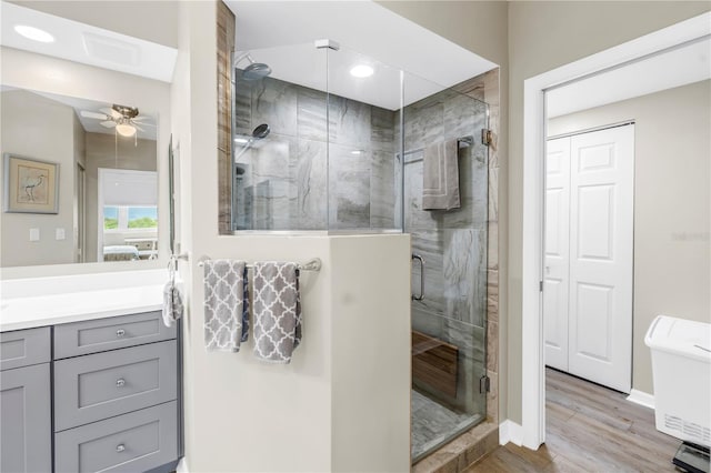6399 Shoreline Dr Unit 4201, Saint Petersburg, FL 33708 - bathroom with ceiling fan, vanity, wood finished floors, a shower stall, and recessed lighting