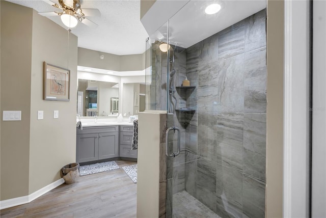 6399 Shoreline Dr Unit 4201, Saint Petersburg, FL 33708 - full bath with vanity, wood finished floors, a stall shower, and a ceiling fan
