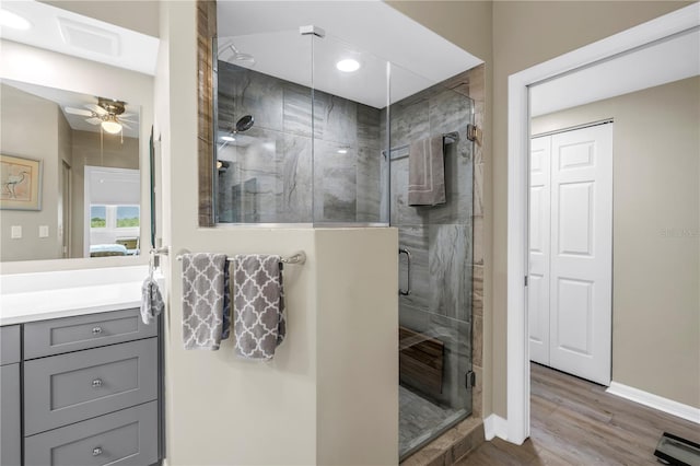 6399 Shoreline Dr Unit 4201, Saint Petersburg, FL 33708 - bathroom with a ceiling fan, vanity, wood finished floors, and a shower stall