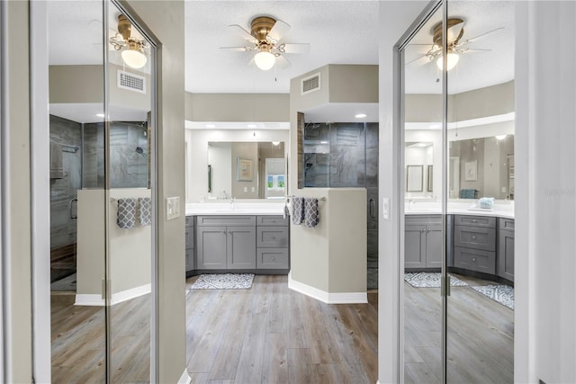6399 Shoreline Dr Unit 4201, Saint Petersburg, FL 33708 - bathroom with ceiling fan, a shower stall, vanity, and wood finished floors