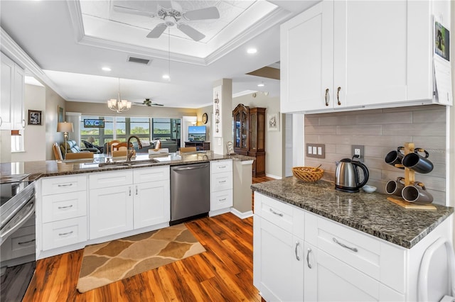 6399 Shoreline Dr Unit 4201, Saint Petersburg, FL 33708 - kitchen featuring appliances with stainless steel finishes, dark wood-style flooring, open floor plan, ceiling fan, and backsplash