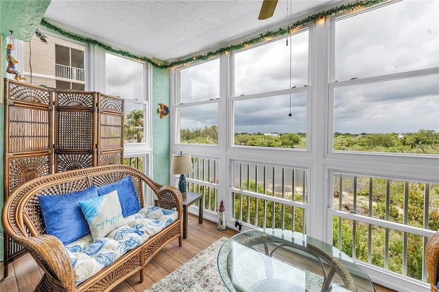 6399 Shoreline Dr Unit 4201, Saint Petersburg, FL 33708 - sunroom / solarium featuring ceiling fan, a textured ceiling, wood finished floors, and an outdoor living space