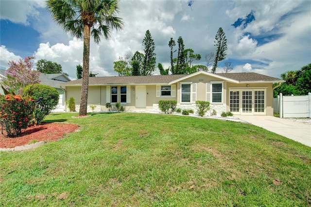 2442 Dando St, Port Charlotte, FL 33948 - single story home with stucco siding, french doors, and concrete driveway