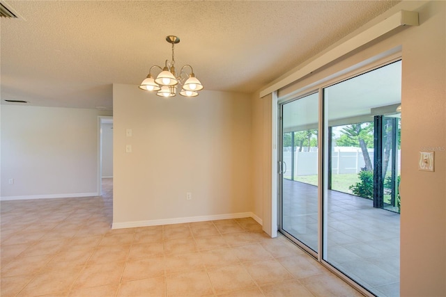 2442 Dando St, Port Charlotte, FL 33948 - unfurnished room featuring a textured ceiling and a chandelier