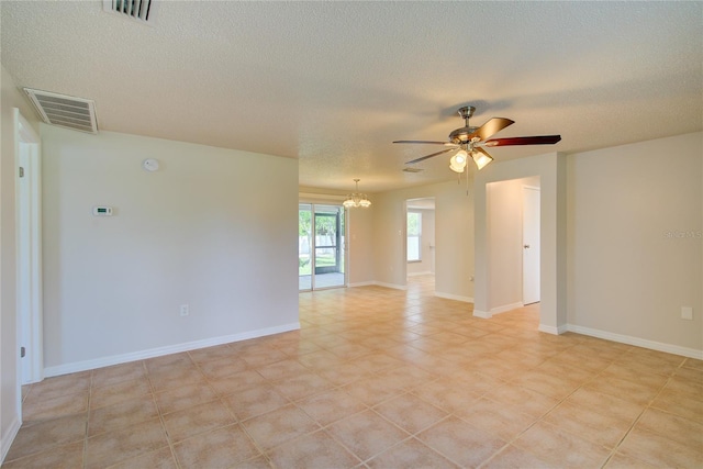 2442 Dando St, Port Charlotte, FL 33948 - empty room featuring a chandelier, a textured ceiling, a ceiling fan, light tile patterned floors, and a smoke detector