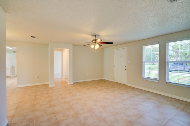 2442 Dando St, Port Charlotte, FL 33948 - empty room featuring a ceiling fan and a textured ceiling