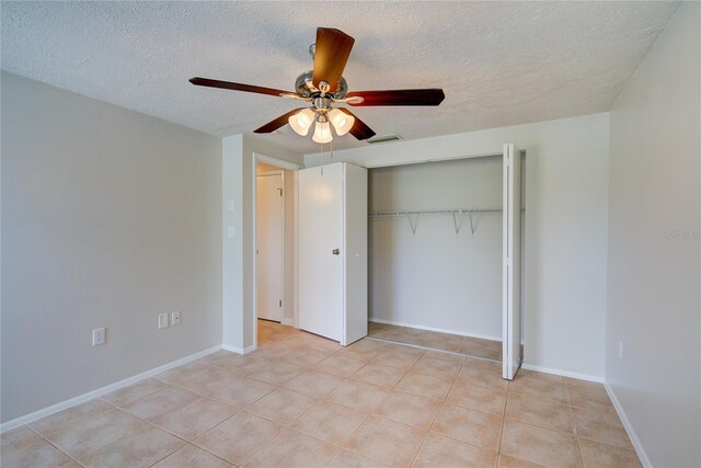 2442 Dando St, Port Charlotte, FL 33948 - unfurnished bedroom featuring a textured ceiling, a closet, a ceiling fan, and light tile patterned floors