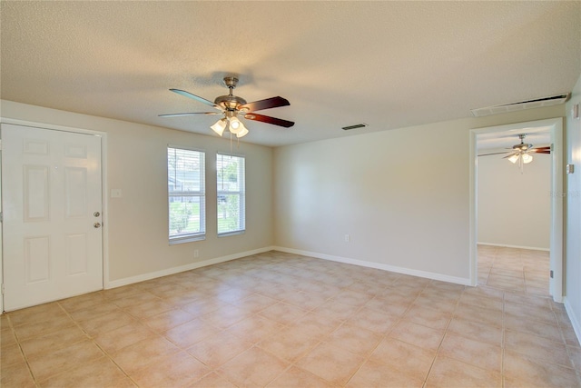 2442 Dando St, Port Charlotte, FL 33948 - empty room featuring a ceiling fan and a textured ceiling