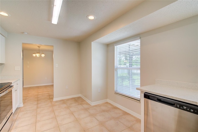 2442 Dando St, Port Charlotte, FL 33948 - kitchen featuring appliances with stainless steel finishes, a textured ceiling, a chandelier, white cabinetry, and light countertops