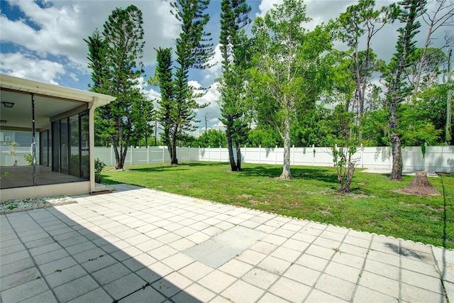 2442 Dando St, Port Charlotte, FL 33948 - fenced backyard featuring a sunroom and a patio area