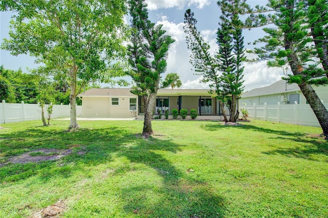 2442 Dando St, Port Charlotte, FL 33948 - back of property featuring a fenced backyard and stucco siding