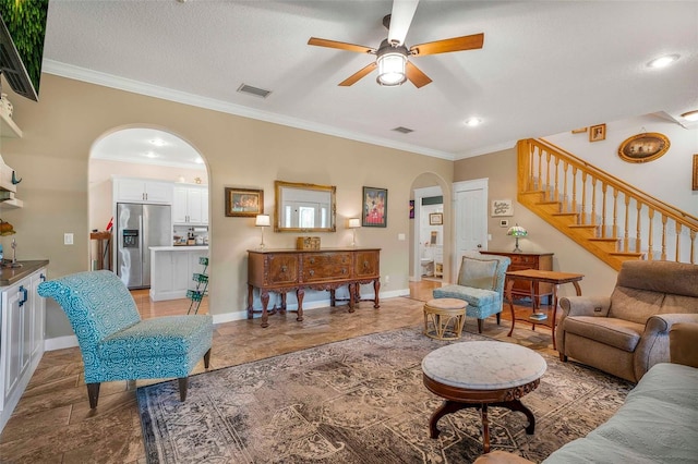 828 E Savoy St, Lecanto, FL 34461 - living area featuring arched walkways, ceiling fan, stairway, ornamental molding, and light stone finish flooring
