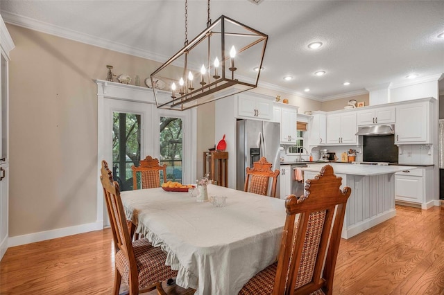 828 E Savoy St, Lecanto, FL 34461 - dining room with light wood-style flooring, crown molding, and recessed lighting