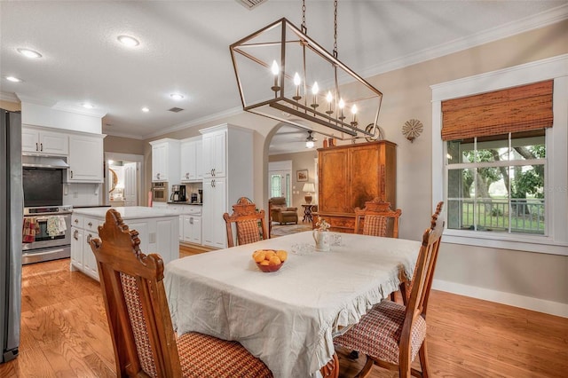 828 E Savoy St, Lecanto, FL 34461 - dining room with ornamental molding, arched walkways, light wood-style flooring, and recessed lighting